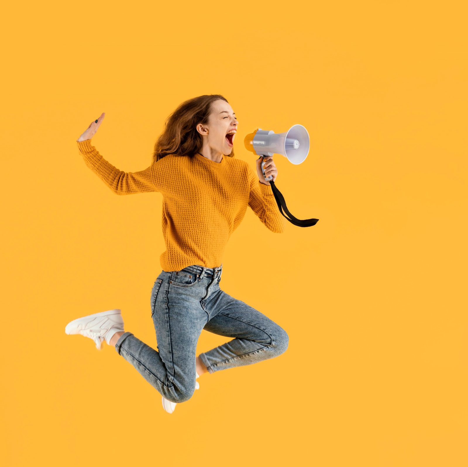 portrait-young-female-jumping-with-megaphone (2)